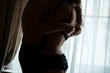 © DenisProduction.com - Couple hugging in the dark. Hands of man unzipping bra. Take it off.