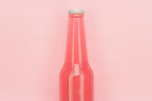 Glass Bottle Of Pinkish Soda Drink On Pink Background