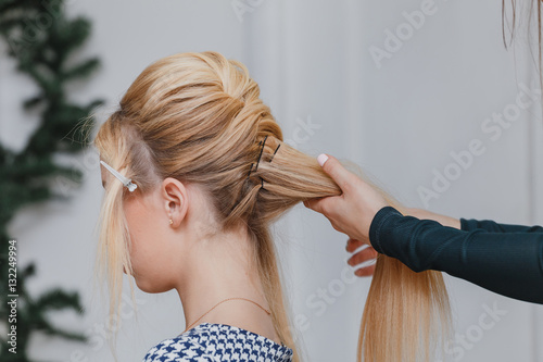 Hairdresser Doing French Twist Hairstyle At Beauty Salon