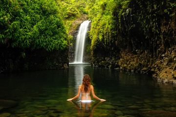 Wall Mural - Young woman in bikini standing at Wainibau Waterfall on Taveuni