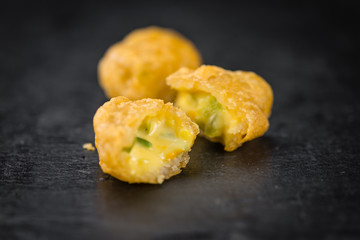 Wall Mural - Cheese Nuggets (with Chilis) on a vintage slate slab (selective