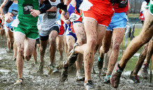 High School Boys Racing Cross Country In The Mud