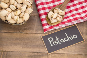 Pistachios with salt on wooden background