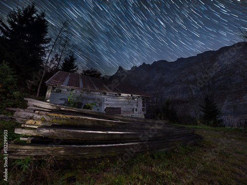 Long Exposure Startrails Over Mountains And Creepy Cabin In The