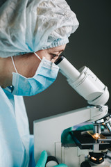 Wall Mural - close up view of scientist eye looking at microscope.