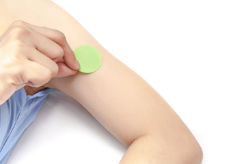 Stick anti mosquito patch on arm, on white background isolated