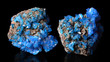 Blue mineral crystals Covellite on a black background.