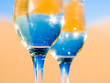 Two glasses of champagne on a desert
