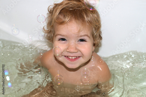 Little White Toddler With Curly Hair And Blue Eyes Emotionally S