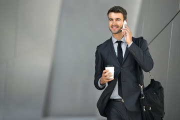 Wall Mural - Business man investor active walking and talking on cellphone networking executive