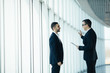 © F8  \ Suport Ukraine - Two businessmen having informal meeting in modern office