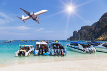 Speedboats Moored In The Tropical Sea With Airplane Landing Above On Blue Sky With Sunlight. Travel Destinations Concept.