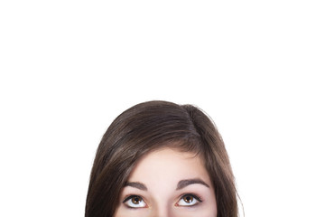 Eyes of brunette woman looking up dumbfounded isolated on white