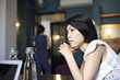 © Andy Paul - Japanese businesswoman leaning on a table during an office meeting