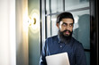 © Andy Paul - Asian businessman standing in an office doorway