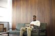 © Andy Paul - Black businessman in an office break out area
