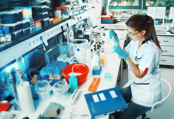 female scientist working in the laboratory, this image is toned.
