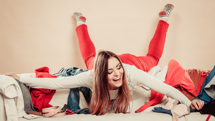 Wall Mural - Woman lie on sofa full of clothes.