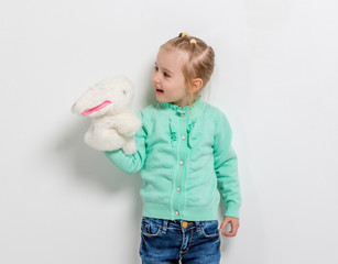 Wall Mural - cute smiling girl playing toy hare