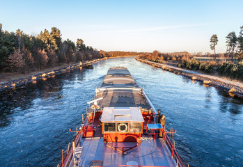 inland vessel drives a canal river along