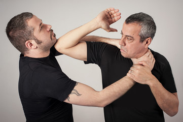 Wall Mural - Street fighting self defense technique against holds and grabs