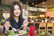 happy asian woman smiling at camera having healthy lunch