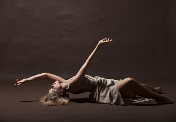 Wall Mural - Young beautiful dancer in beige dress