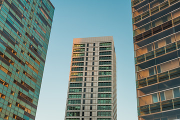 Trio of buildings with hint of sunlight on sides