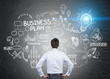 © ImageFlow - man looking at business plan sketch