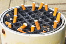 Cigarette Stubs In Dirty Ashtray Outdoor