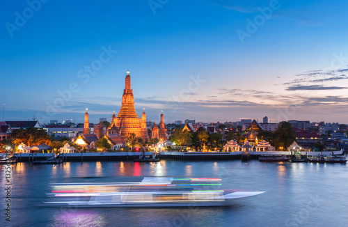 The boat was sailing in Chao Phraya River, background Wat Arun at sunset time ,Bangkok, Thailand Poster