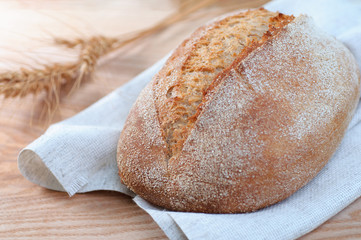 loaf of bread on wooden background, closeup view