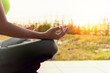 © 88studio - young woman meditates while practicing yoga outdoor in park,  re