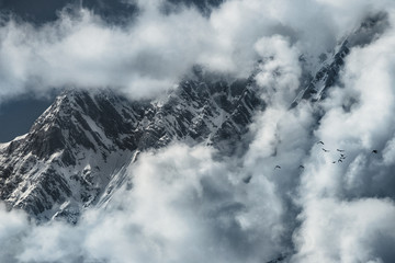 Dawn in the mountains, when a lot of clouds, glaciers