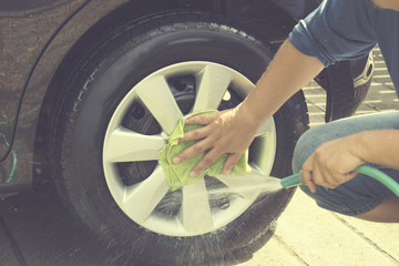 Washing car with Water hose and Green Towel