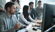 Software engineers working in office on project together