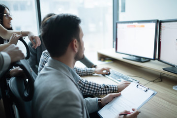 Software engineers working in office on project together