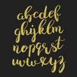 Glitter gold script alphabet. Shiny brush calligraphy typeface
