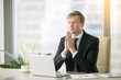 © fizkes - Young businessman working at desk in yoga pose, praying, meditating, relaxing. Stress free work, time for practice, mindfulness and wellbeing, stay healthy on physical, mental emotional level concept