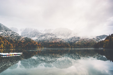 Boats on lake water and coniferous autumn Forest landscape Travel concept serene scenic view