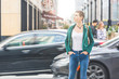 Woman in the city with blurred cars on background