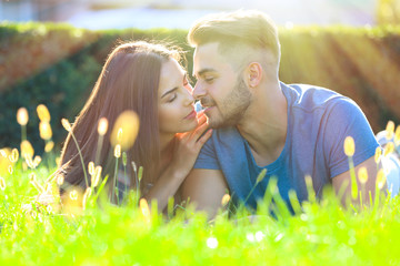 Wall Mural - Lovely couple lying on green grass