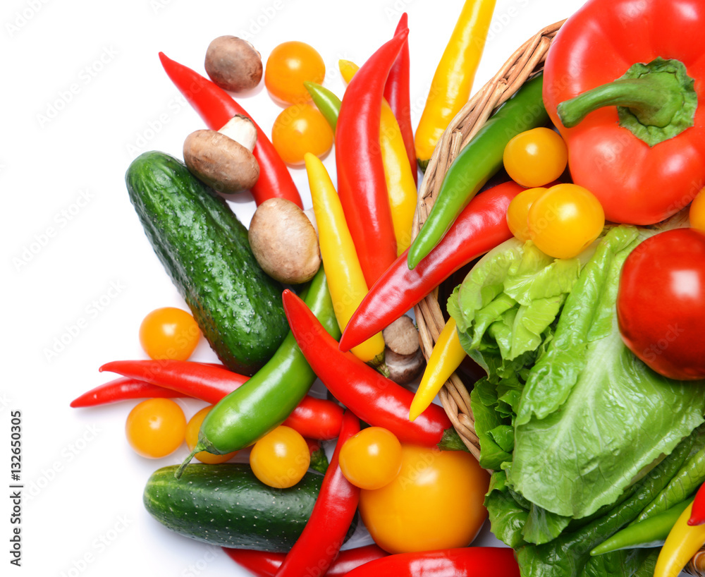 Group of fresh vegetables in basket on white background