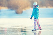 
Ice skating. Young girl is skating on a natural frozen lake.
