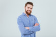 © Drobot Dean - Happy handsome young man standing with arms crossed