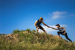 © torwaiphoto - Trail runner are helping women runner from a slope.