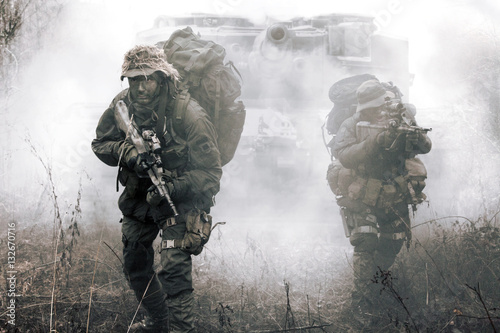 Fotografie, Tablou Jagdkommando soldiers Austrian special forces and tank moving on terrain in the fog