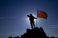 Soldier On Top Of A Mountain With A Chinese Flag