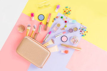 Colorful make up products with golden pursue pop art flat lay scene