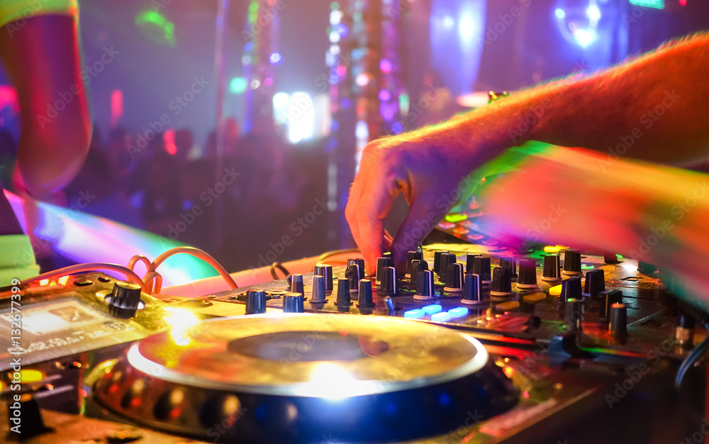 Close up of dj playing party music on modern cd usb player in disco club - Nightlife and entertainment concept - Defocused background with shallow depth of field and focus on buttons near mixing hand - obrazy, fototapety, plakaty 